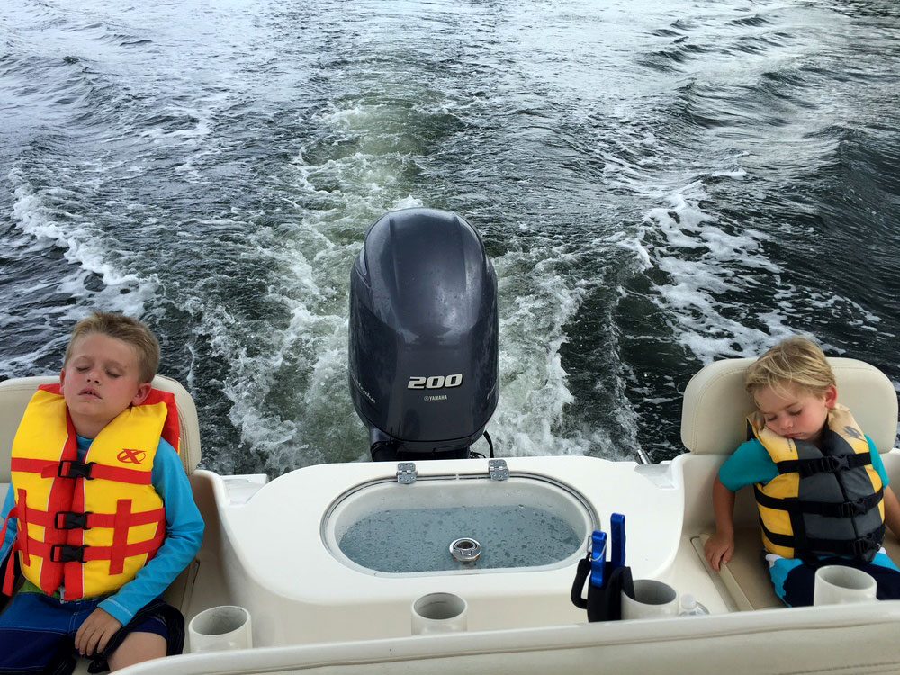Children wearing life jackets asleep on fishing boat Tampa, Florida