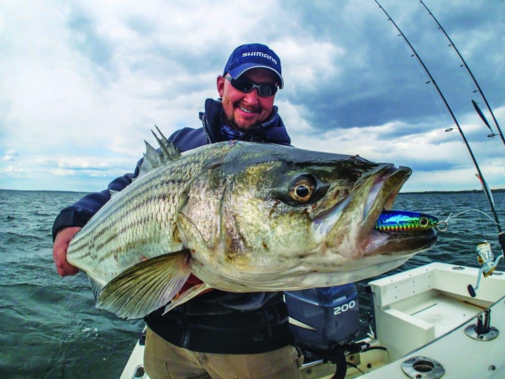 Fisherman holding a big striper