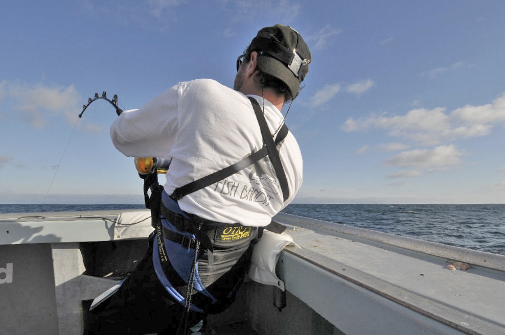 Fisherman on stand-up tuna fishing gear