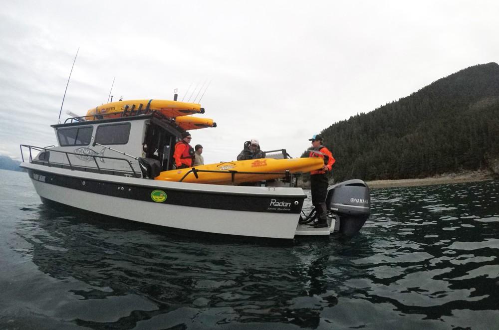 Offloading kayaks to fish for salmon in Resurrection Bay, Alaska