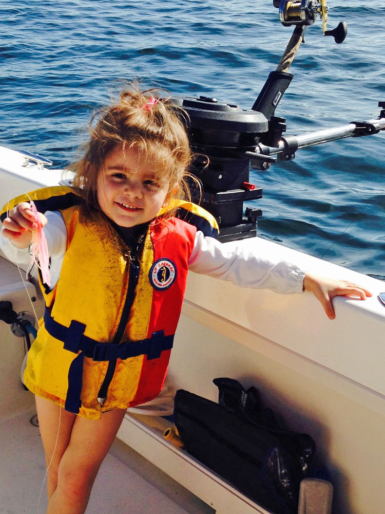 Girl wearing life jacket fishing boat Camano Island, Washington