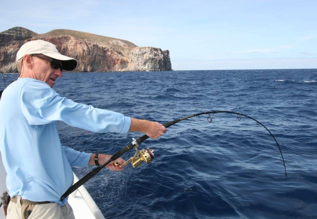 Fisherman deep sea fishing with a saltwater spinning reel