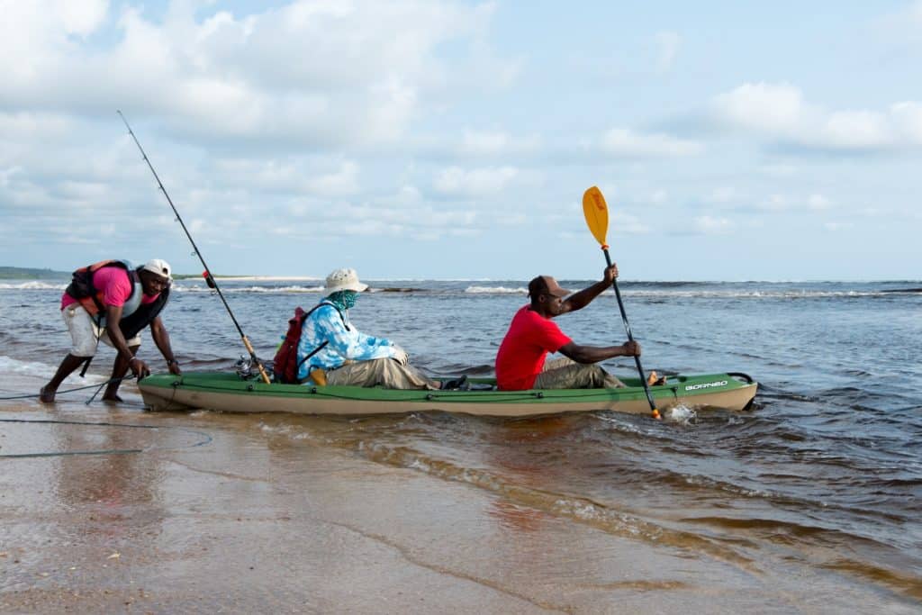 Fishing Gabon on the west African coast - catching a ride in a kayak