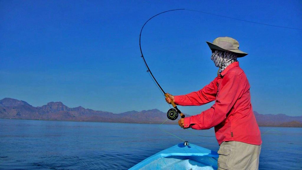 Woman casting a fly-fishing rod in Loreto, Baja California Sur, Mexico
