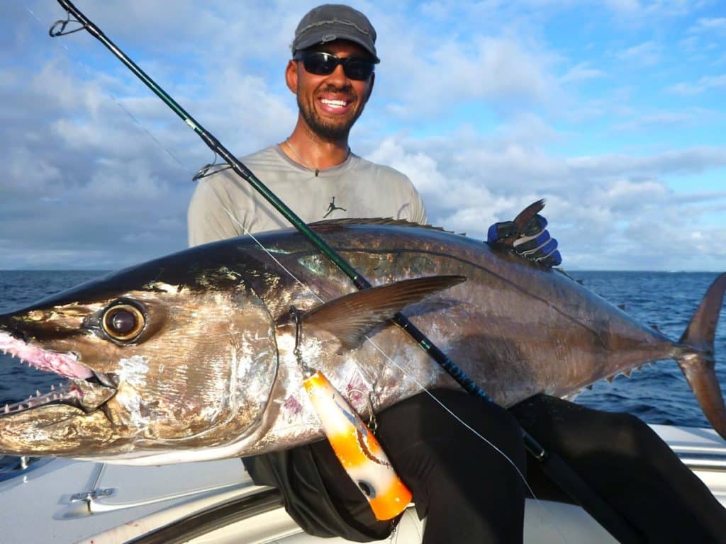 Fisherman holding a dogtooth tuna fish caught while fishing in Vanuatu