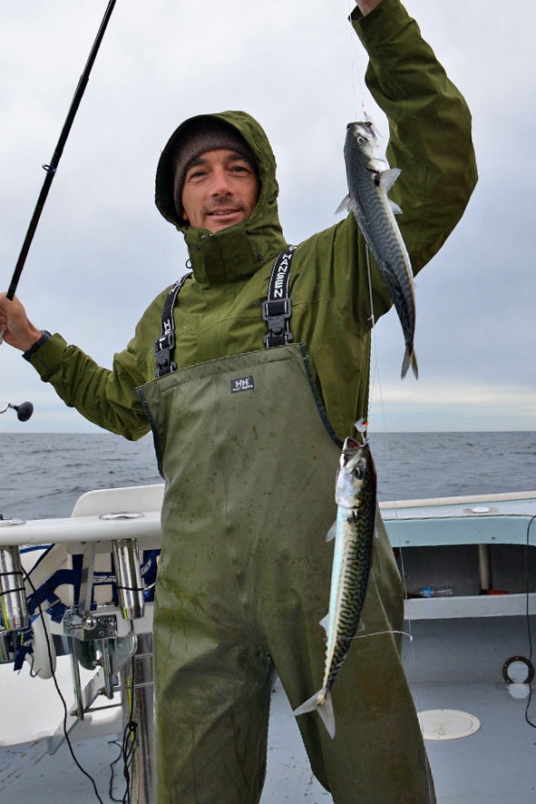 PEI fisherman holding mackerel baitfish