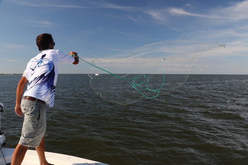 Capt. Sonny Schindler throws a castnet