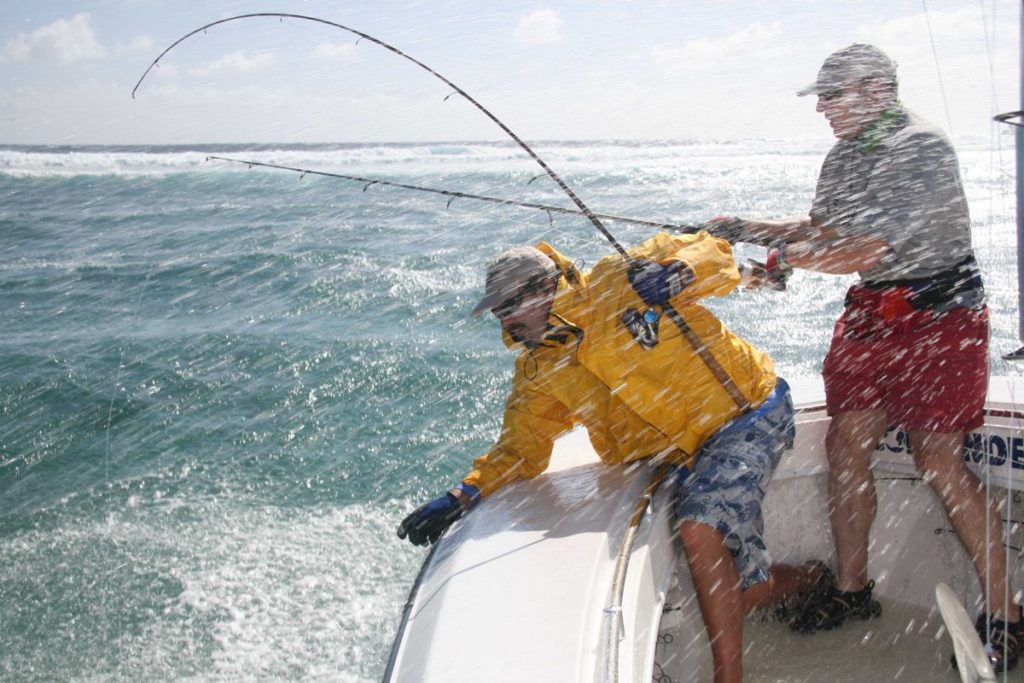 Fisherman caught in the salt sea spray while deep sea fishing saltwater spinning reel