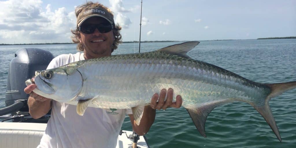 Capt. Ed Walker holding a tarpon