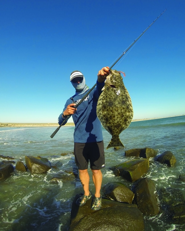 Rock fisherman holding halibut fish