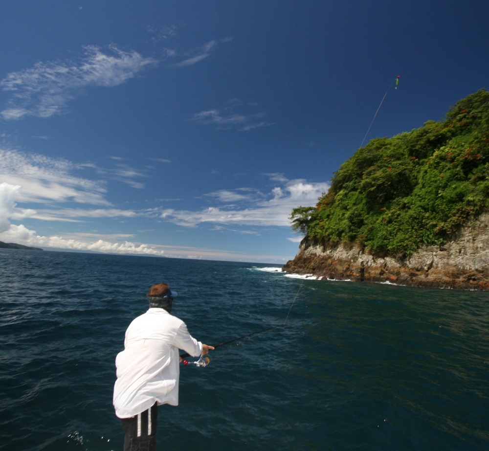 Fisherman casting deep sea fishing saltwater spinning reel