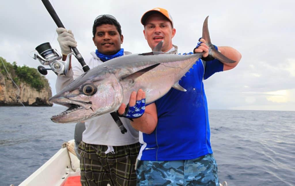 Two anglers with a dogtooth tuna