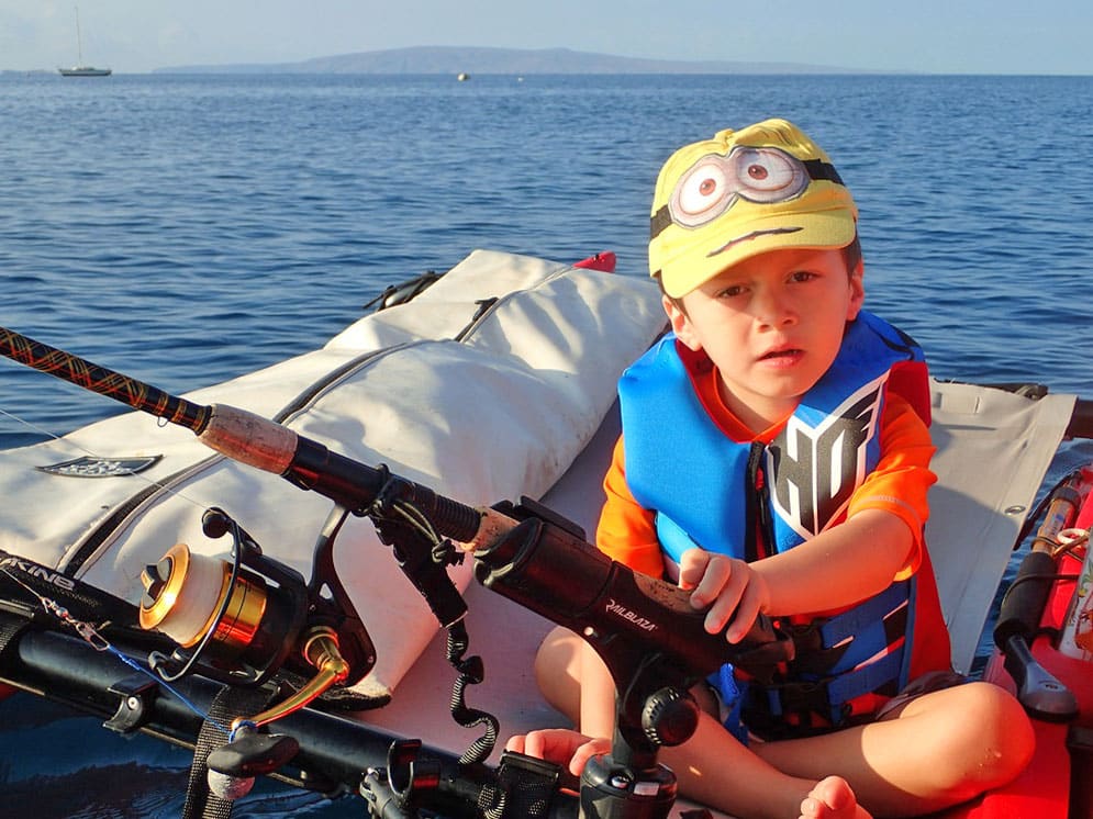 Boy wearing PFD on a fishing kayak Kihei Maui, Hawaii