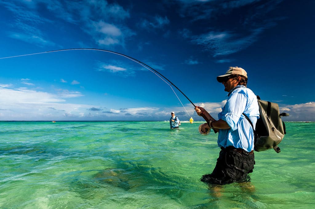 Dazzling fishing photography of Henry Gilbey - battling a giant trevally on fly rod