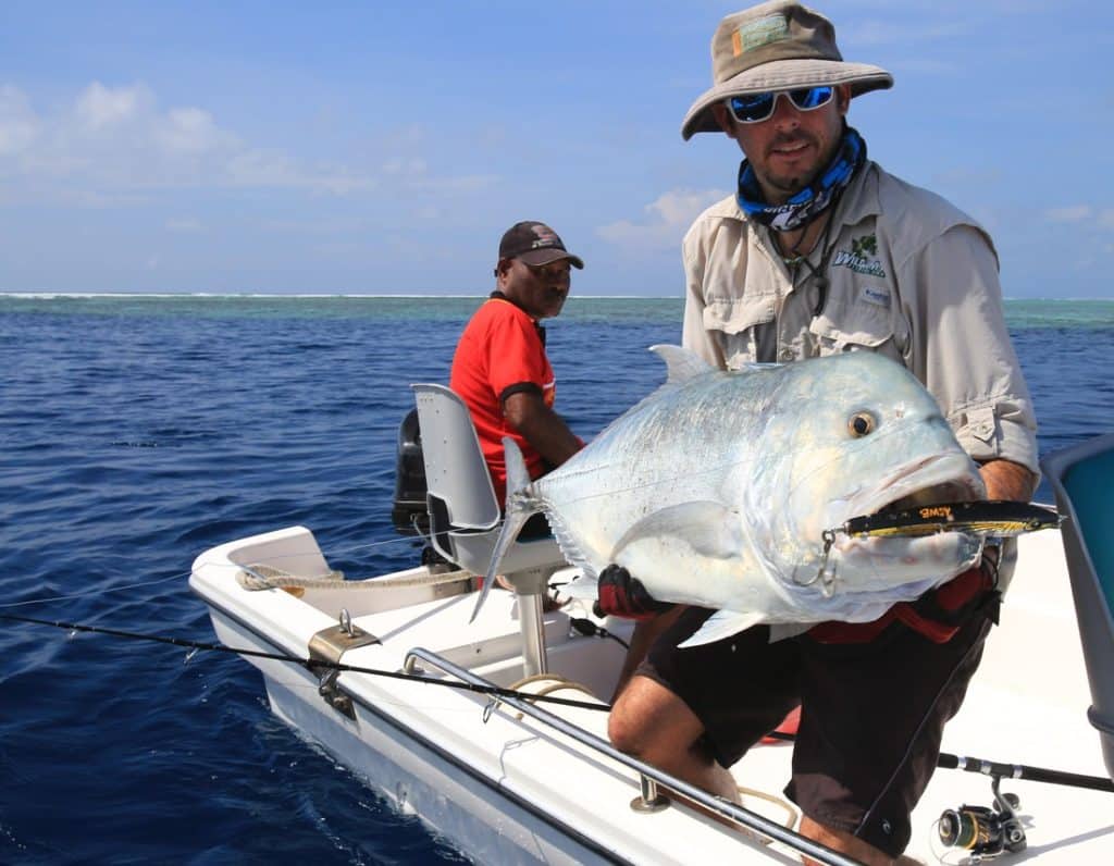 Giant trevally held by fisherman