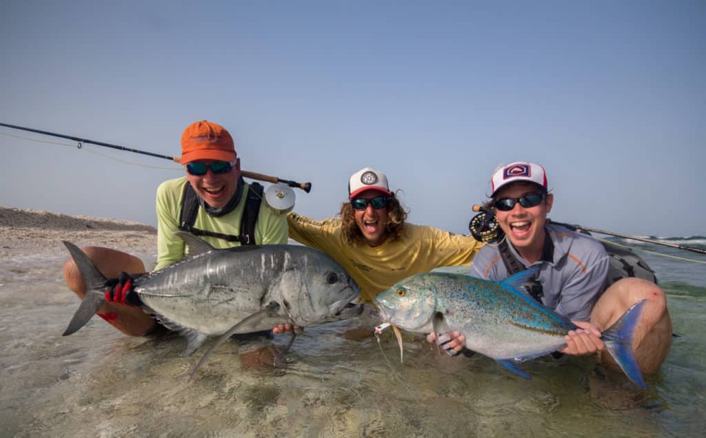 Fishermen holding bluefin trevally fishing Red Sea