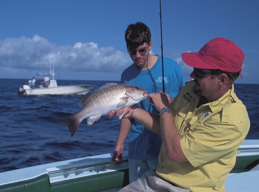 Key West fishing produces a nice gray snapper for a young fisherman