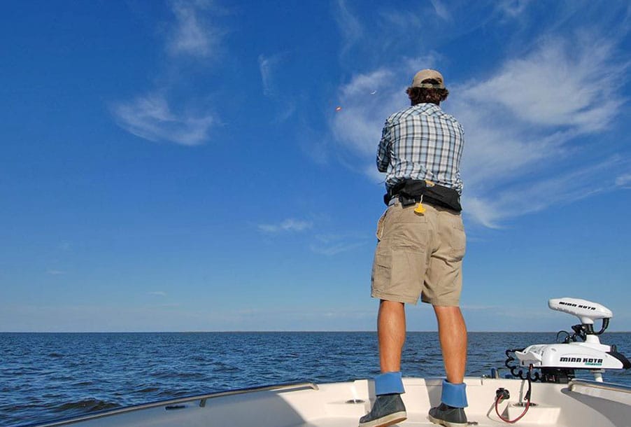 Angler casting a fishing rod in North Carolina's Pamlico Sound
