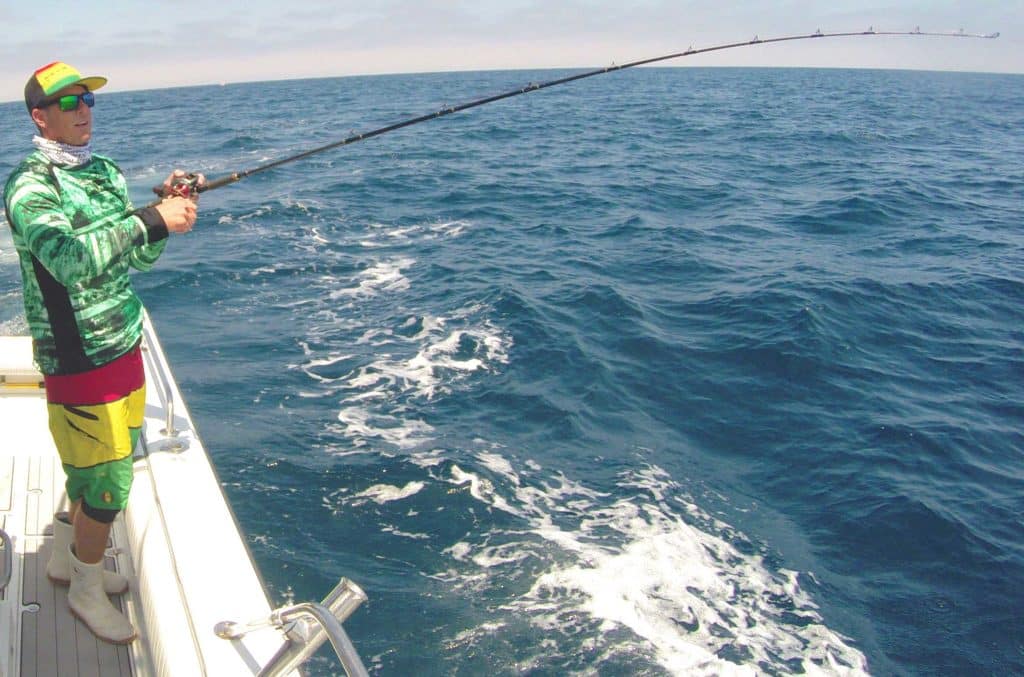 Battling a tuna using a low-profile reel