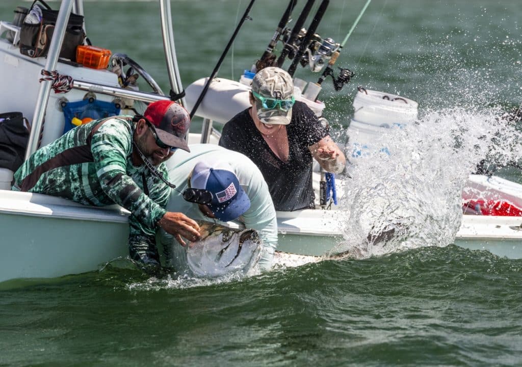 Holding a large tarpon