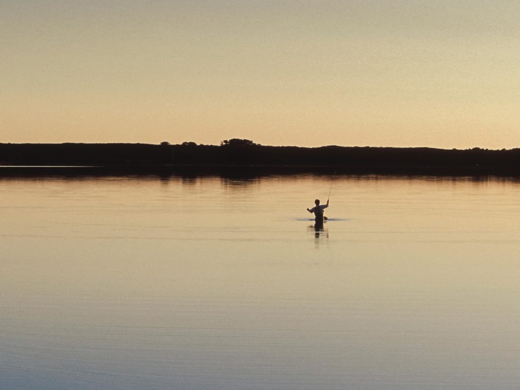 Angler fishing at sunrise