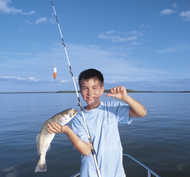 A young angler is thrilled to have caught a seatrout.