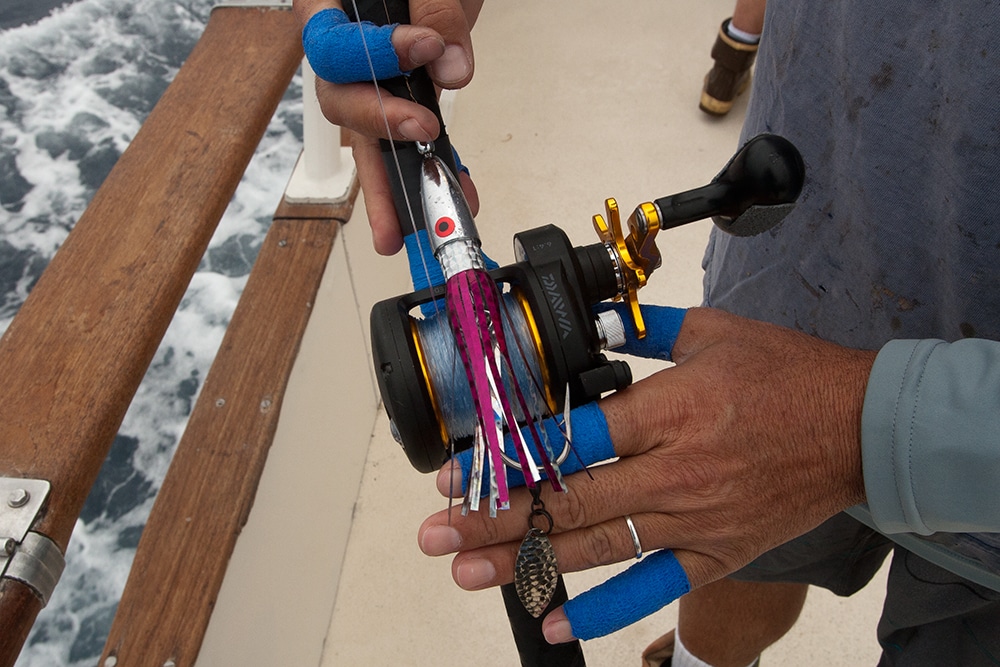 Deep sea fishing rod and offshore reel with skirted wahoo lure