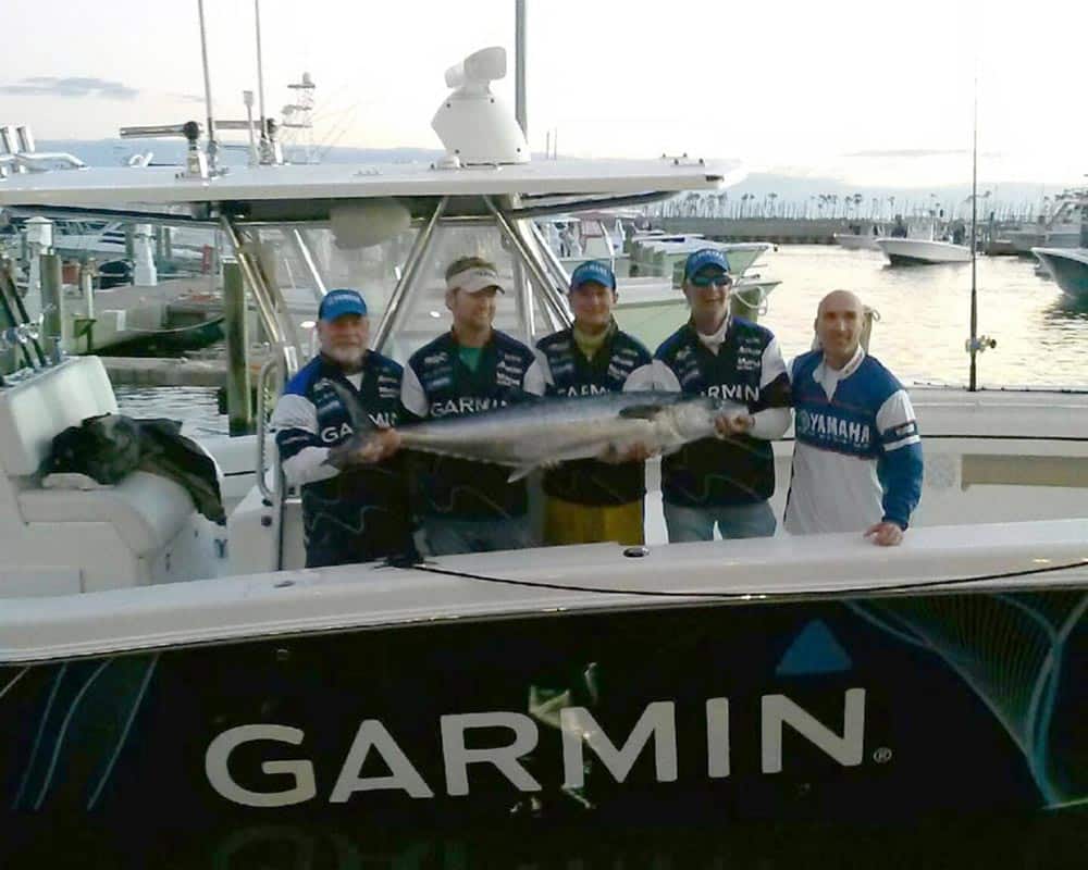 Anglers holding fish caught on 36 Invincible center console fishing boat
