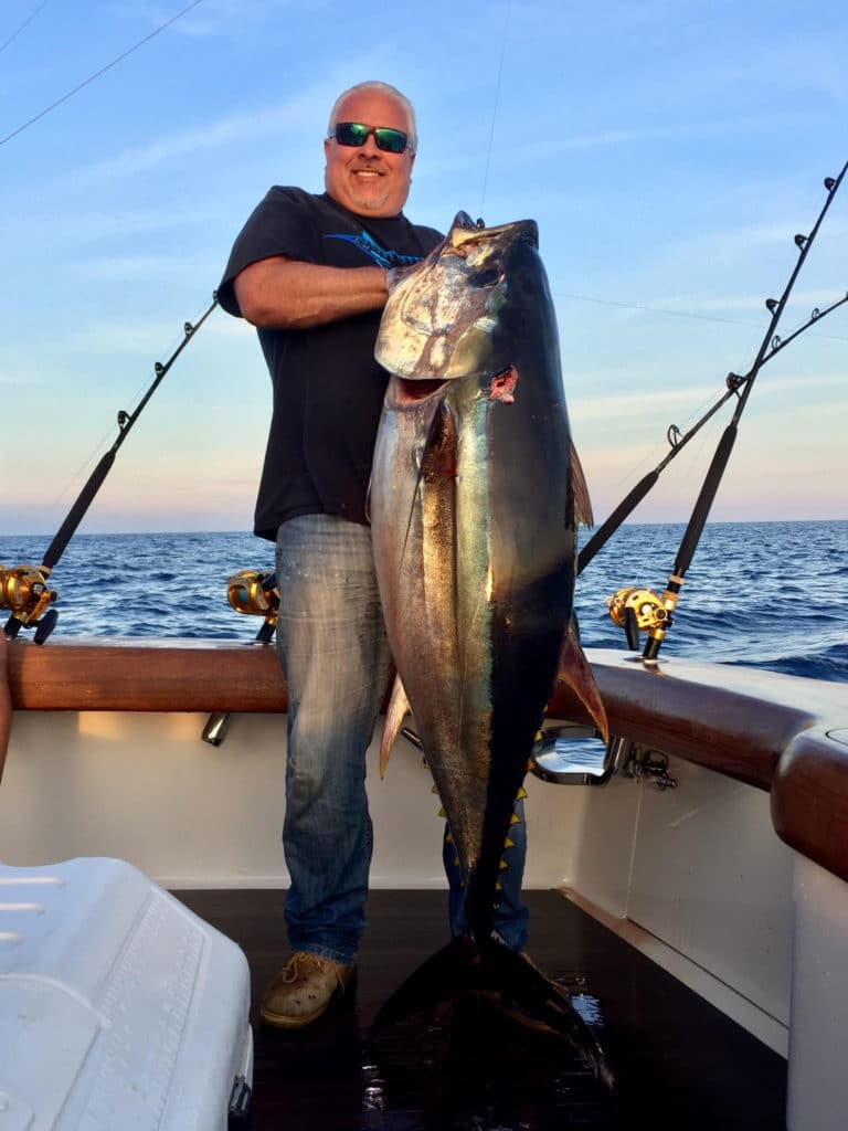 Capt. Mark DeBlasio holding a large tuna