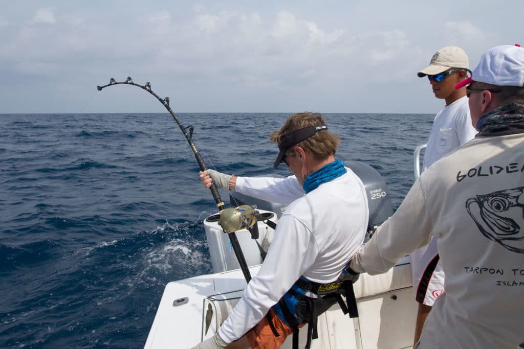 Sportfishing angler deep sea fishing on small center console boat