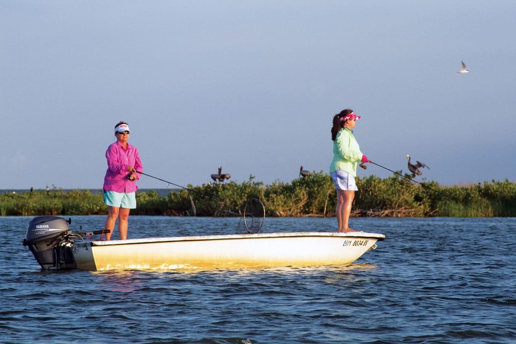 Female anglers casting fishing skiff Chandeleur Islands, Louisiana