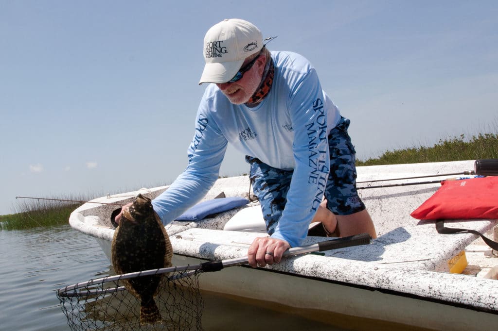 Angler holding flounder caught fishing Chandeleur Islands Louisiana