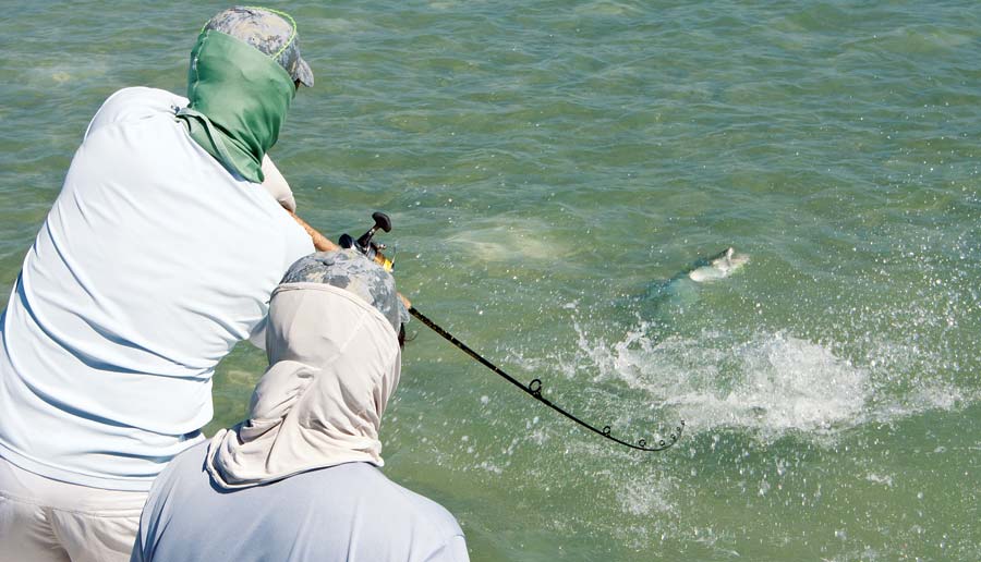 Anglers hooked up barracuda flats fishing boat