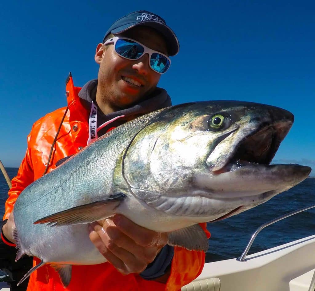 Angler holds large Chinook salmon off BC coast