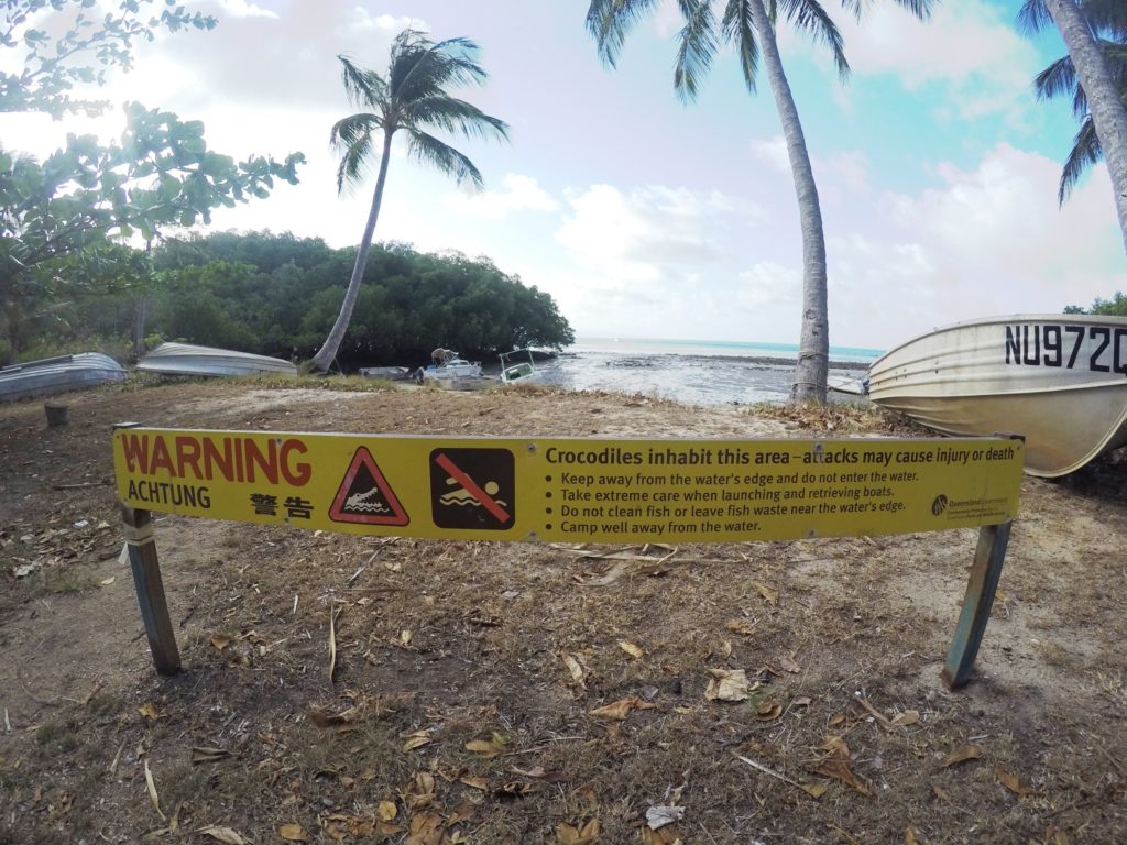 Sign warning of crocodiles on a beach