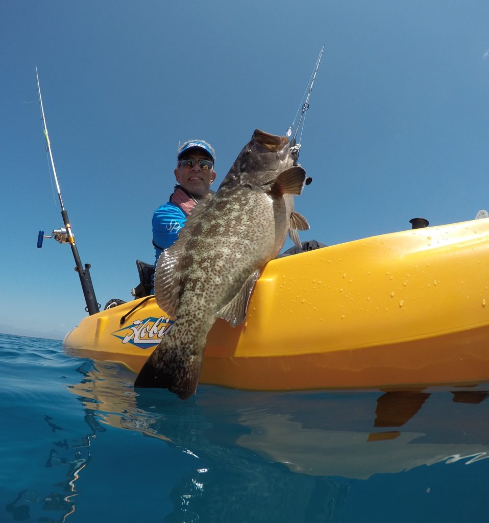 saltwater fisherman releasing cabrilla Hobie kayak fishing Baja’s Central Sea of Cortez