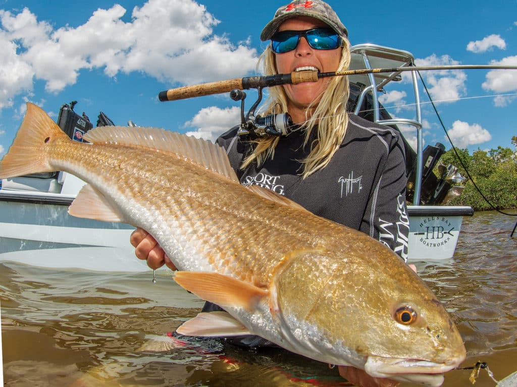 Female angler holding redfish