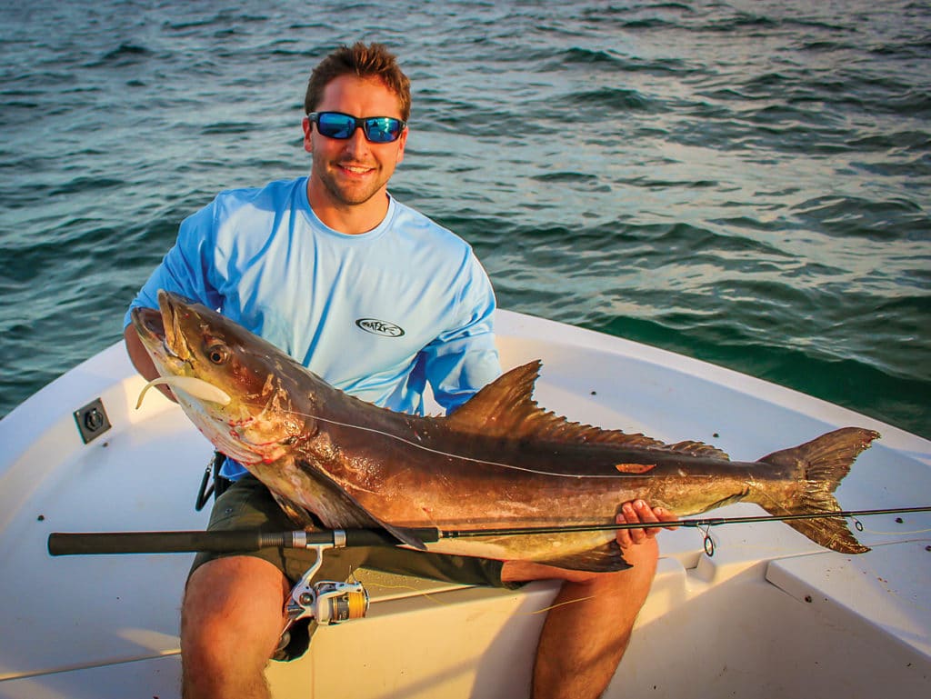 Angler holding cobia caught fishing light tackle