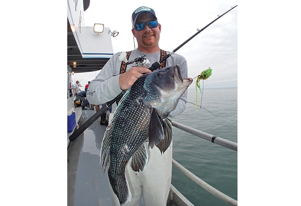 Offshore fisherman with fish caught on slow jig fishing lure