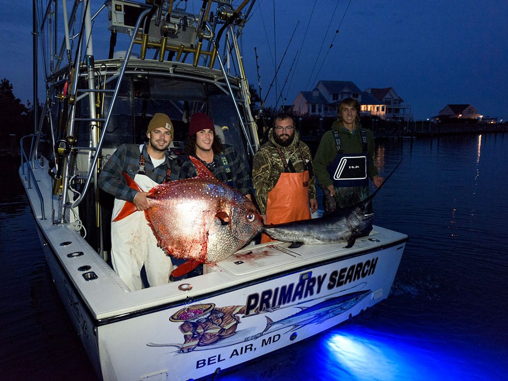 guys holding rare opah