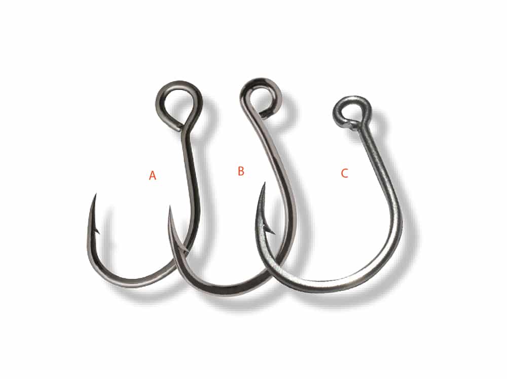 Three saltwater in-line single fishing hooks used to switch out treble hooks on fishing lures