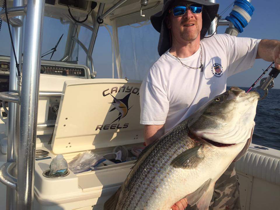 Capt. Rob Crocitto, a Sport Fishing Charter Captain of the Year 2017, with a striped bass