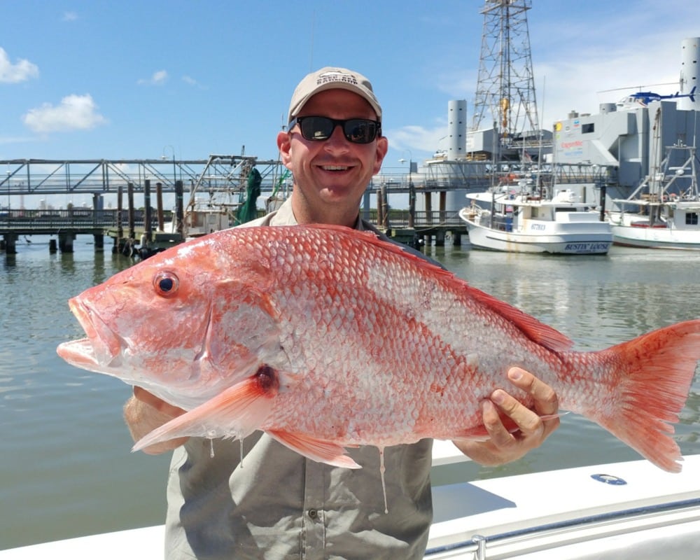Robert E. Jones holding red snapper caught saltwater fishing