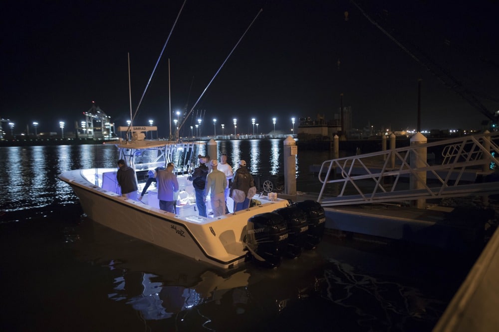 A group of anglers leaves the dock pre-dawn to head offshore.