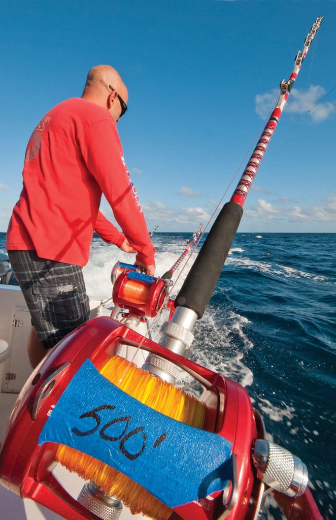Angler manning a fishing rod and reel while offshore trolling