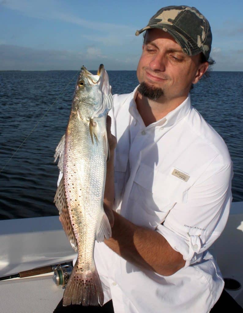 Man holding a freshly caught trout