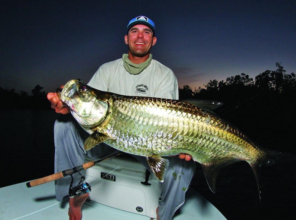 Angler holding tarpon fishing Everglades Florida