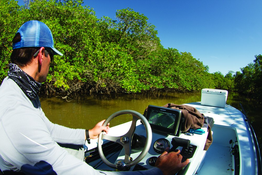 Angler driving skiff fishing Everglades Florida