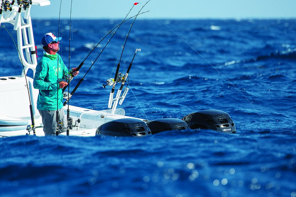 An angler feeds line to a fish in vey rough conditions