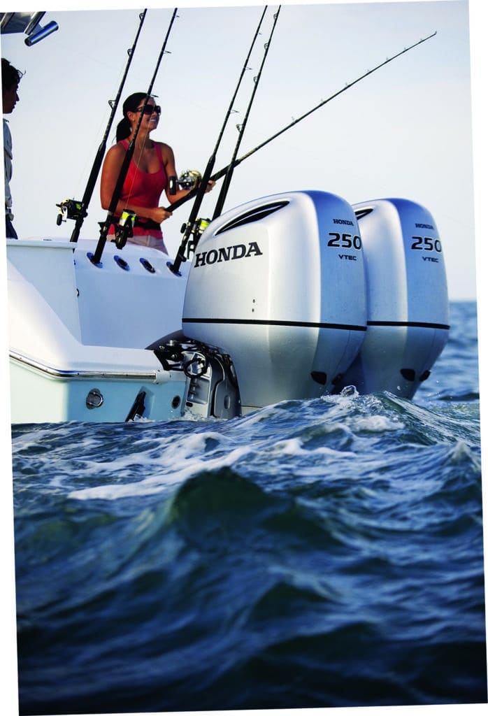 Twin Honda Marine outboard boat engines hanging on a sport fishing boat deep sea fishing
